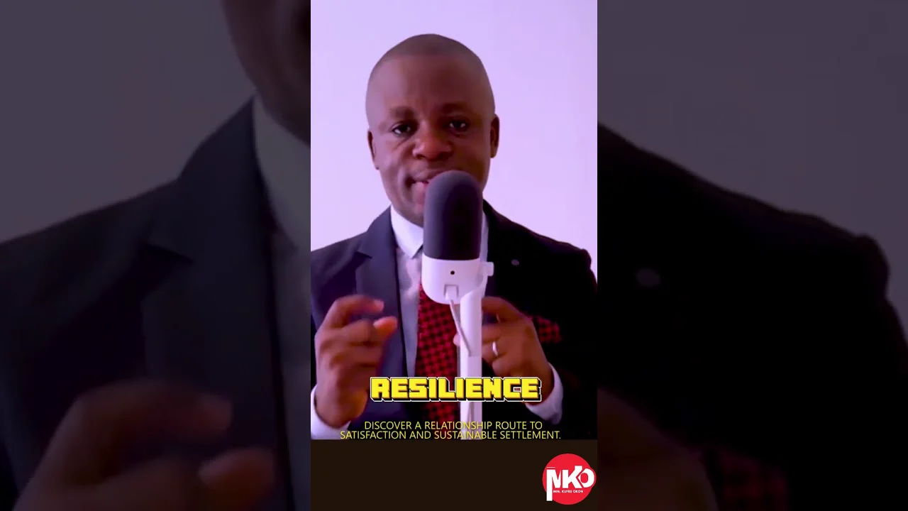 Kufre Okon at a desk microphone, with the word Resilience on screen, in Shoot Your Shot, episode five.